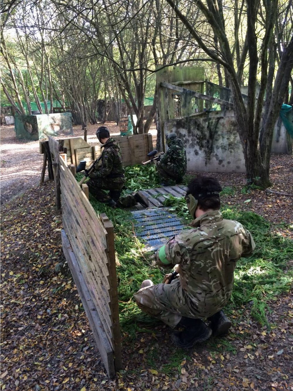Players behind a wooden barricade mid game